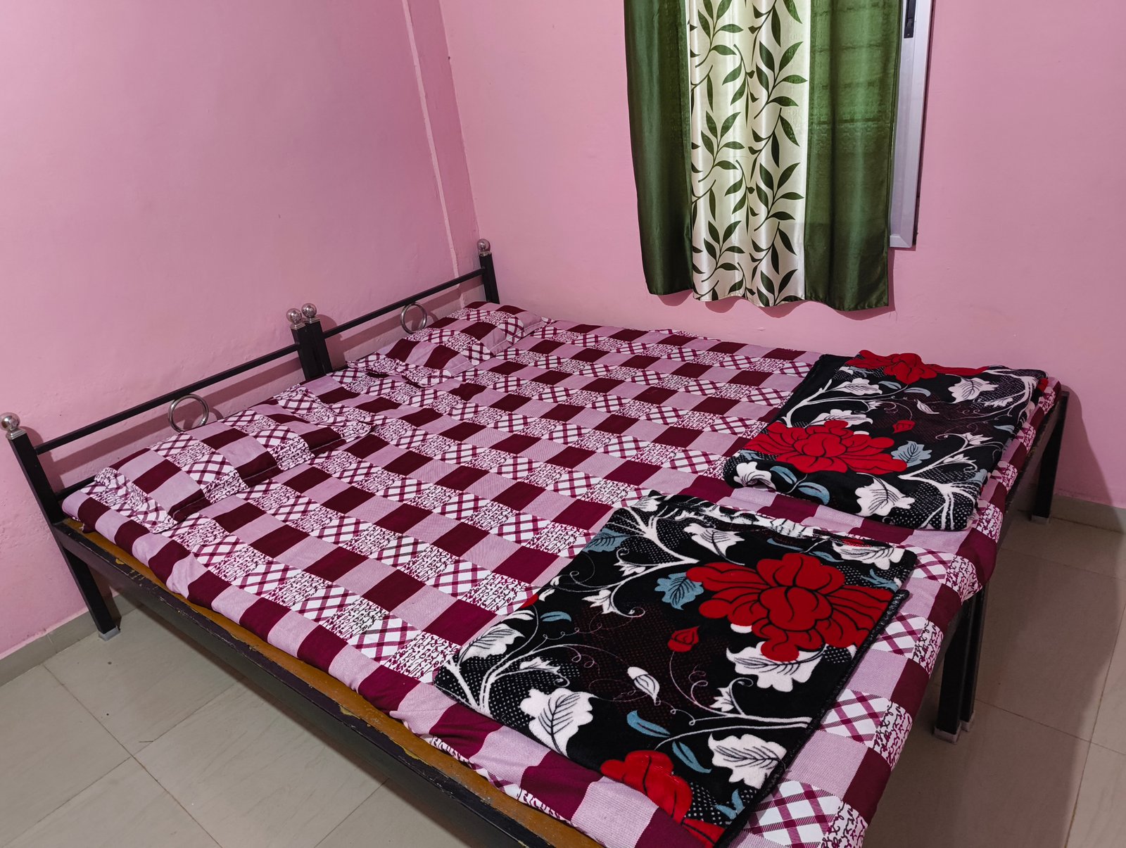 A cozy double bed in a pink room